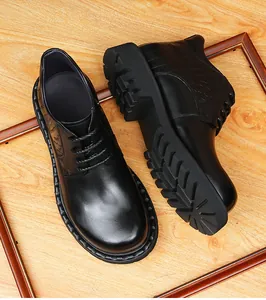 Close-up detail of men's black leather boots with crocodile texture and thick lug sole