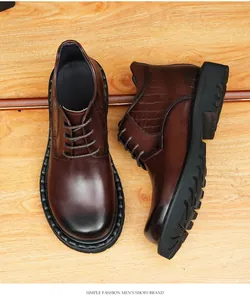 Detailed view of men's brown leather boots featuring crocodile pattern and thick soles