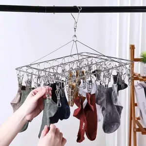 Detailed view of a durable stainless steel multi-clip laundry rack drying various socks