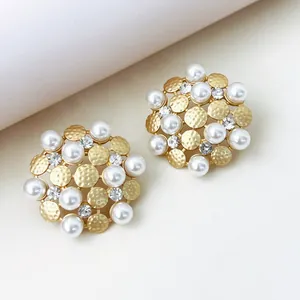 Elegant close-up of vintage sunflower stud earrings featuring pearls and rhinestones.