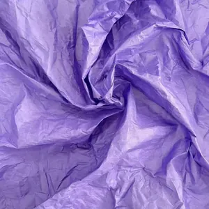 Close-up macro detail of textured purple wrinkled tissue paper for DIY floral crafts
