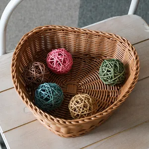 Heart-shaped woven imitation rattan basket for fruits and snacks on wooden table
