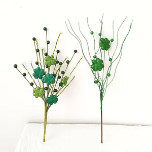 Detailed view of glittered green shamrock picks for St. Patrick's Day decorations.