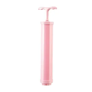 Manual pink air pump for vacuum storage bags, durable tool for home organization.