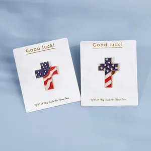High-quality macro view of American flag cross enamel pins on white display cards