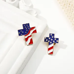 Pair of cross-shaped metal brooches featuring American flag stars and stripes design