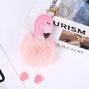 Detail shot of a pink plush flamingo keychain with heart-shaped feet.