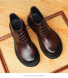Close-up view of stylish brown leather boots for men featuring crocodile pattern details