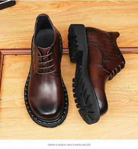 Close-up of men's brown leather boots with crocodile texture and thick sole detail