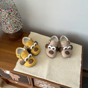 Detailed view of cozy fleece-lined children's winter shoes with cute dog face design