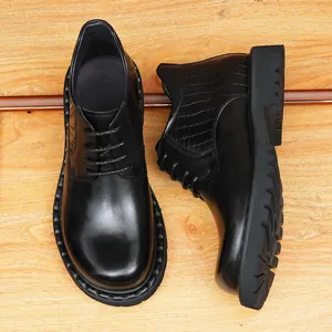 Stylish men's black leather boots with thick soles and crocodile pattern accents