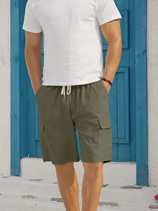 Men's olive green corduroy cargo shorts featuring functional side pockets and drawstring waist.