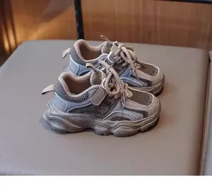 Detailed side view of breathable grey mesh sneakers for girls with stylish thick soles.
