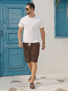 Men's brown corduroy cargo shorts with drawstring waist in a sunny outdoor setting