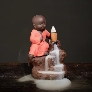 Handcrafted purple clay backflow incense burner featuring a cute monk on a mountain