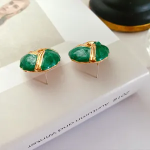Detailed view of vintage green enamel stud earrings with high-quality 925 silver needles