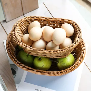 Set of two oval woven fruit and bread storage baskets in a natural rustic home setting