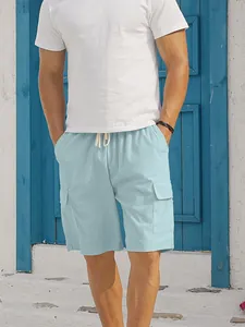 Detail view of men's light blue corduroy cargo shorts featuring side pockets and drawstrings.