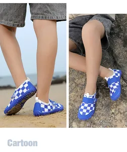 Detailed view of children's blue and white checkered water shoes on a sunny beach