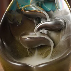 Artistic ceramic backflow incense burner with cascading smoke and iridescent blue glaze