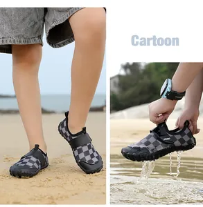 Detailed macro view of kids' checkerboard water shoes on a sandy beach with water splashes