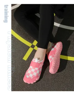 Detail view of pink checkered kids water shoes with non-slip rubber soles and secure fit.