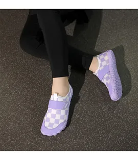 Close-up detail of children's purple and white checkerboard water shoes with adjustable strap