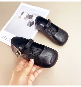 Detailed view of black girls' Mary Jane shoes with gold buckle and soft sole texture