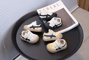 Close-up detail of multi-color toddler sneakers with Velcro straps and panda icon