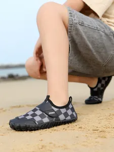 Non-slip breathable kids wading swimming shoes with grey checkered pattern on sandy beach