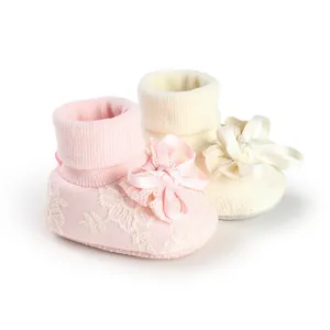 Adorable pink and cream baby girl socks with elegant lace floral patterns and silk bows