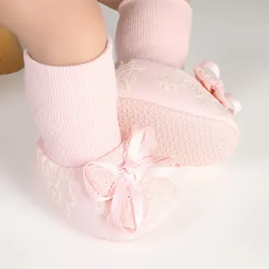 Soft pink baby floor socks with white lace and a cute silk bow for infants 0-18M