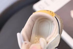 Detailed view of breathable mesh lining and padded collar in baby sneakers