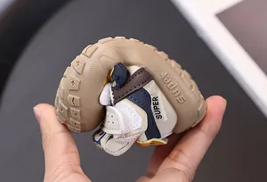 Close-up showing the flexible rubber sole of a toddler walking shoe for softness.