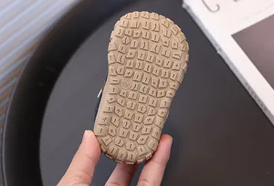 Detail shot of the textured non-slip rubber sole on a baby outdoor walking shoe