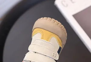 Close-up of the reinforced anti-collision toe and velcro straps on toddler walking shoes.