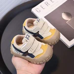 Beige baby walking sneakers with protective toe cap and dual hook-and-loop straps
