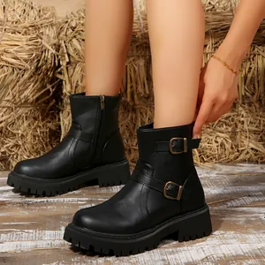 Detailed side view of black chunky ankle boots with buckle straps and side zipper