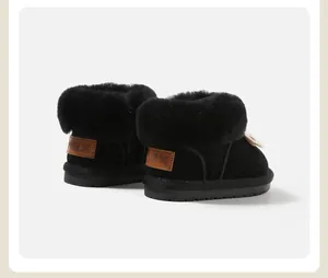 Rear view of black girls' snow boots featuring fluffy fur trim and MBX leather patch.