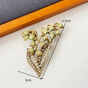 Retro lily of the valley brooch with green drip glaze and sparkling crystal accents