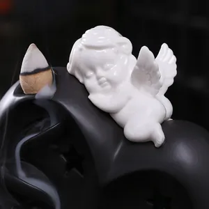 European style Cupid backflow incense burner featuring a ceramic angel and moon base