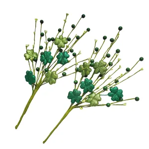 Close-up of glitter-coated green shamrocks and berries on St. Patrick's Day picks