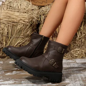 Stylish brown chunky platform ankle boots with decorative buckle details and side zipper.