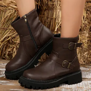 Close-up of side buckle details on brown thick-sole faux leather Martin boots for women