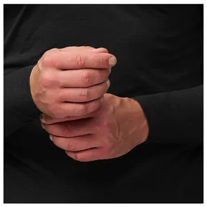 Close-up of black seamless performance fabric on men's long sleeve workout tee