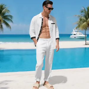 Men's white linen resort set with black trim detail in a tropical beach setting