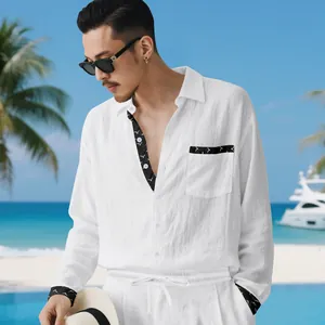 Detail of men's white linen long-sleeve shirt and pants set in a beach holiday setting