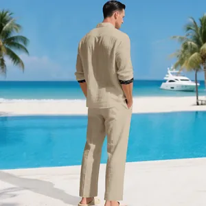 Back view of a men's beige linen shirt and pants set in a tropical beach resort.