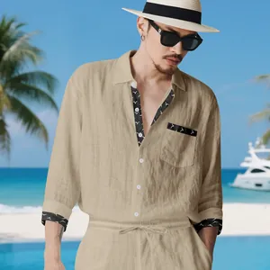Detail of men's beige linen set with bird print trim on shirt collar and cuffs