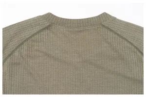 Close-up of olive green breathable honeycomb fabric and durable stitching on sports shirt.